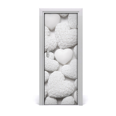 Fototapeta samolepiace na dvere Rozptýlené biele srdiečka na pozadí