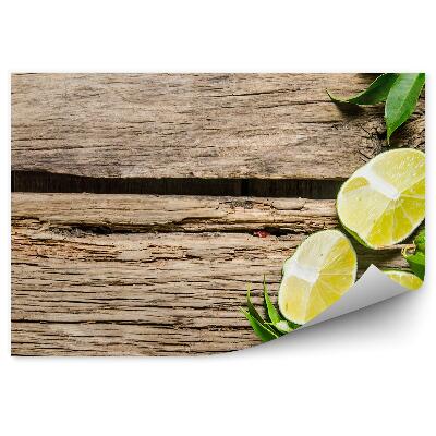 Fototapeta na stenu Zelené plátky limetky rozpolené listy drevo