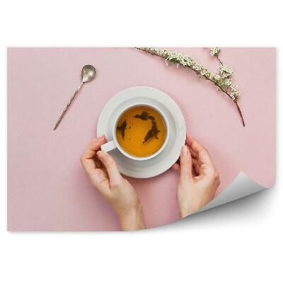 Fototapeta na stenu Ženské ruky biela šálka ružové pozadie vetva kvety