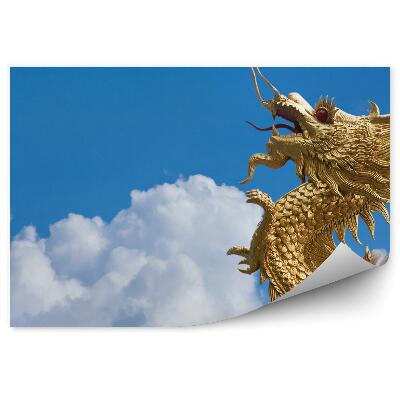 Fototapeta na stenu Zlatý drak letiaci medzi mrakmi na modrej oblohe