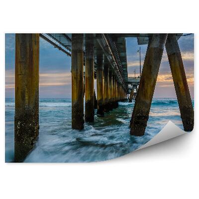 Fototapeta na stenu Vlny oceánu mólo západ slnka