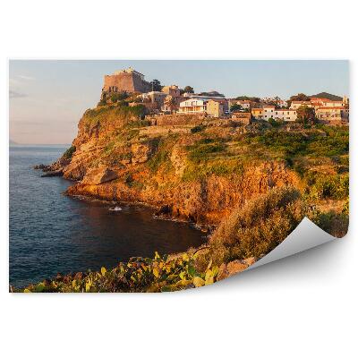 Fototapeta Budovy hory kaktusy zelené skaly oceán obloha mraky kapránia